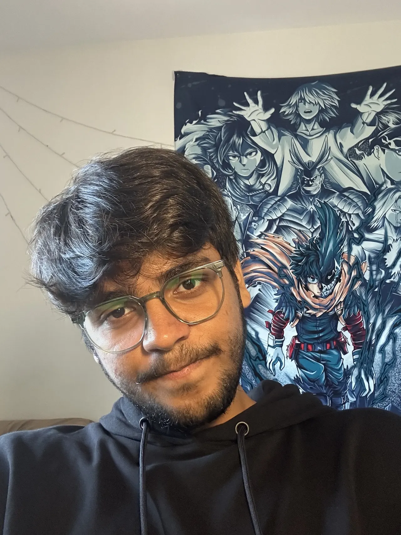 Selfie in front of an anime tapestry