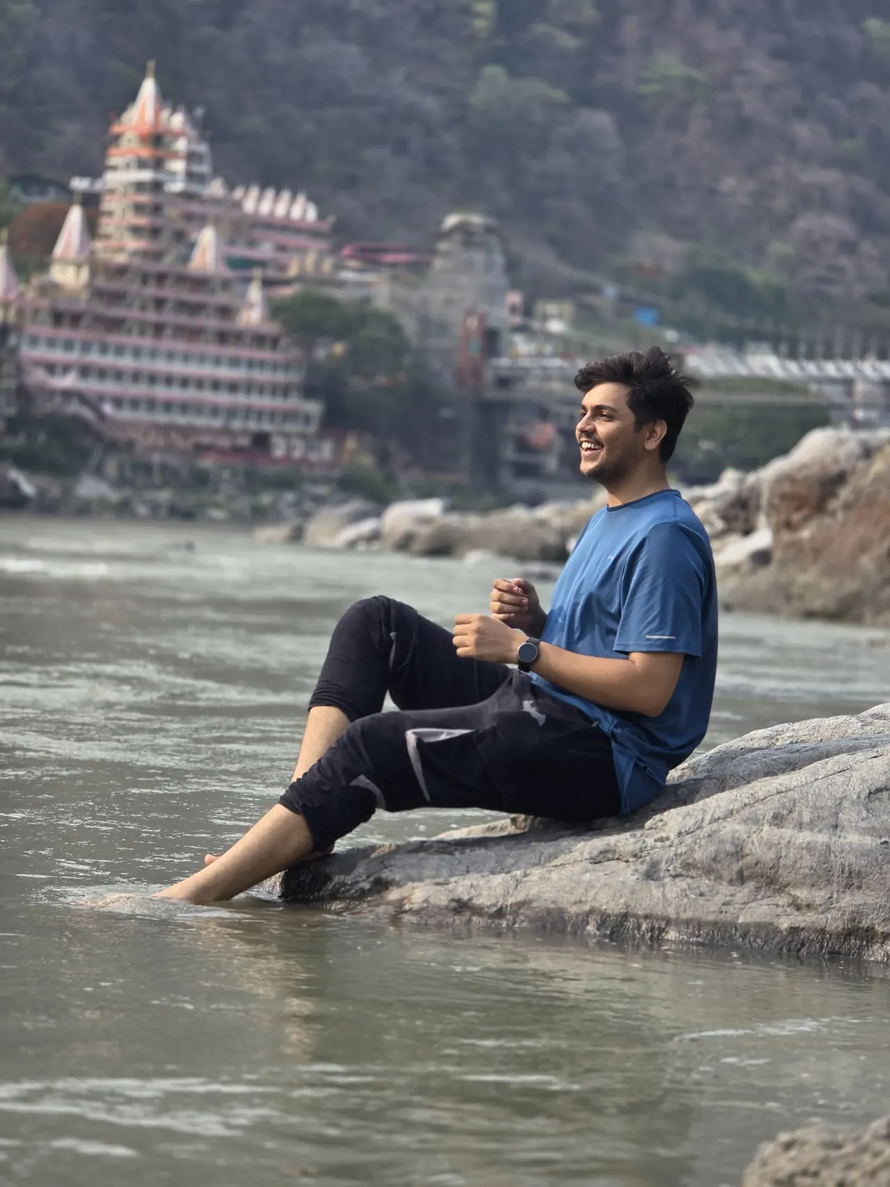 Aditya sitting on a rock in the Ganga at Rishikesh